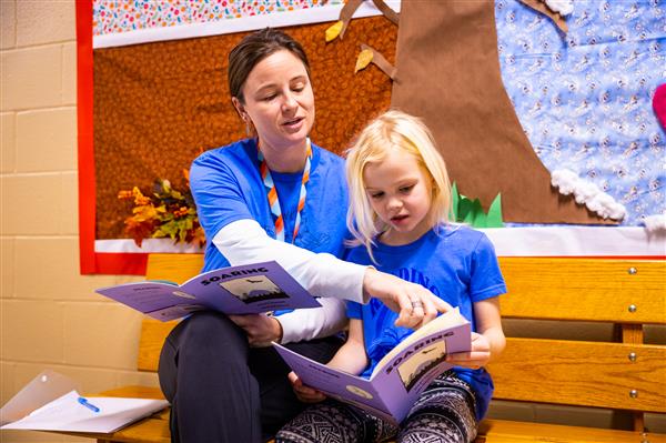 Volunteers reading with students. 